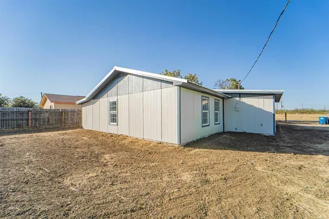 a view of a house with a yard and garage