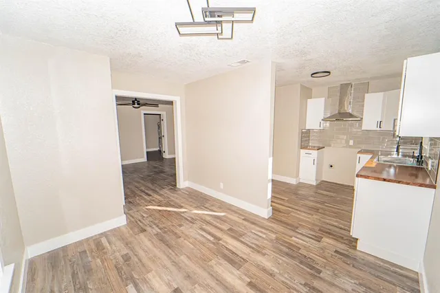 a view of a kitchen from the hallway with a sink