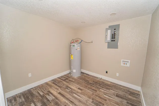 a view of a room with wooden floor and white walls