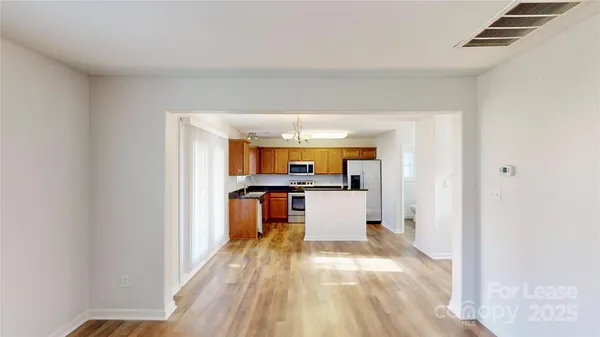 a view of a kitchen with a sink and a refrigerator