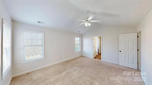 a view of a room with a ceiling fan and a window
