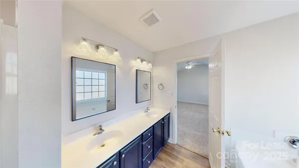 a bathroom with double vanity sink and mirror