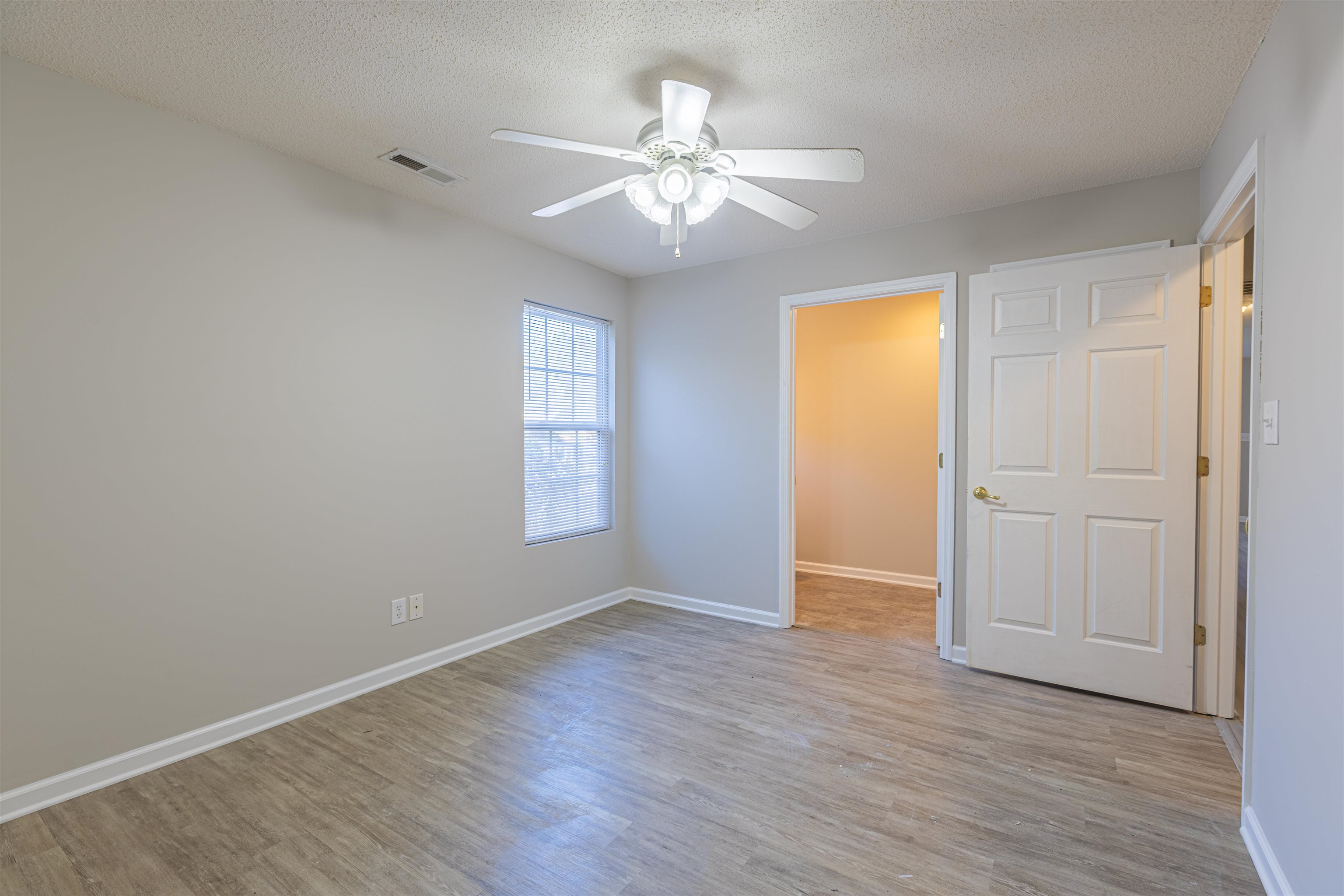 1001 Mistletoe Court Myrtle Beach, SC 29579 - Photo 11 of 28 Kitchen with black appliances, light countertops, white cabinetry, light wood finished floors, and a textured ceiling