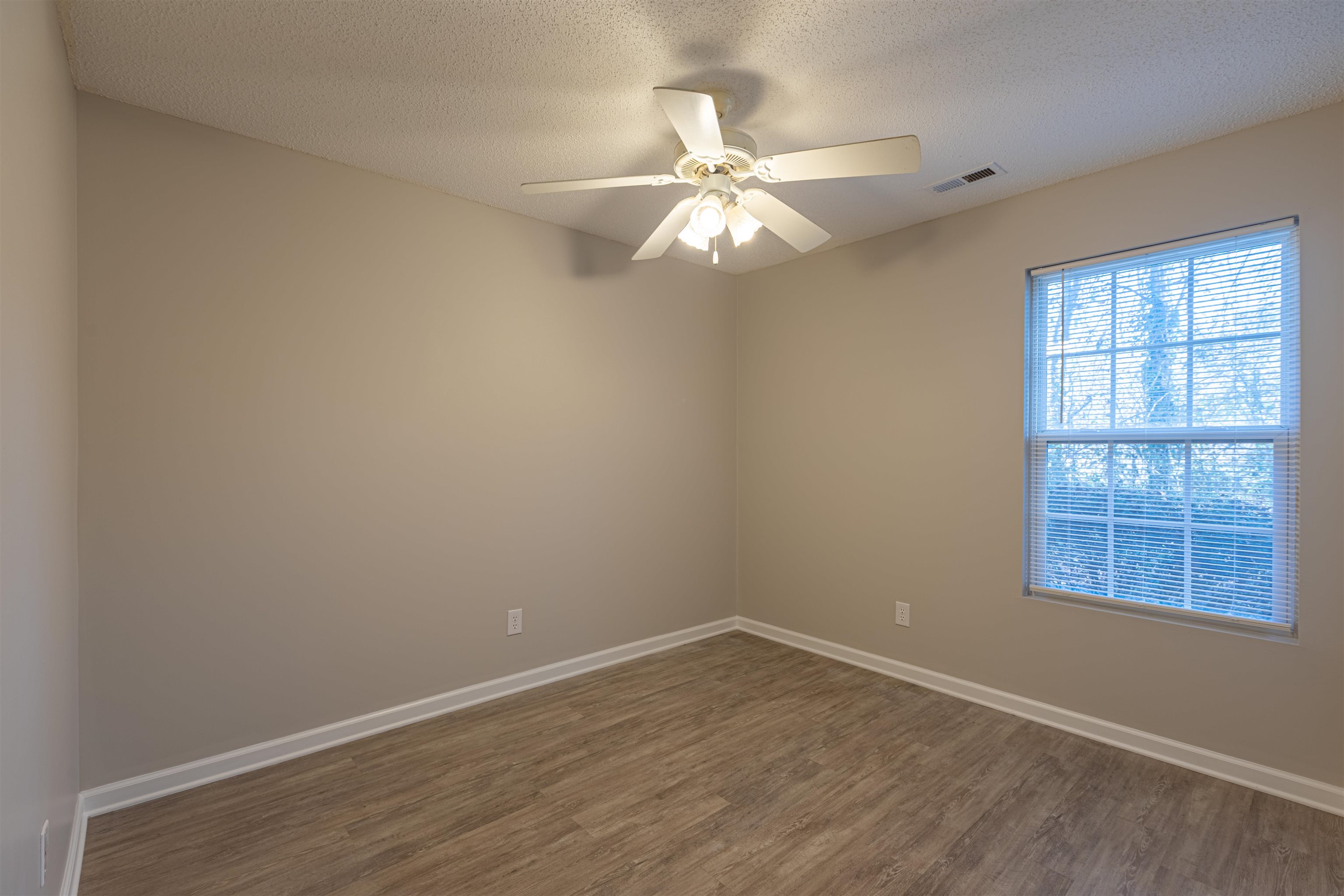 1001 Mistletoe Court Myrtle Beach, SC 29579 - Photo 15 of 28 Unfurnished bedroom with light wood-style floors, a textured ceiling, a closet, and ceiling fan