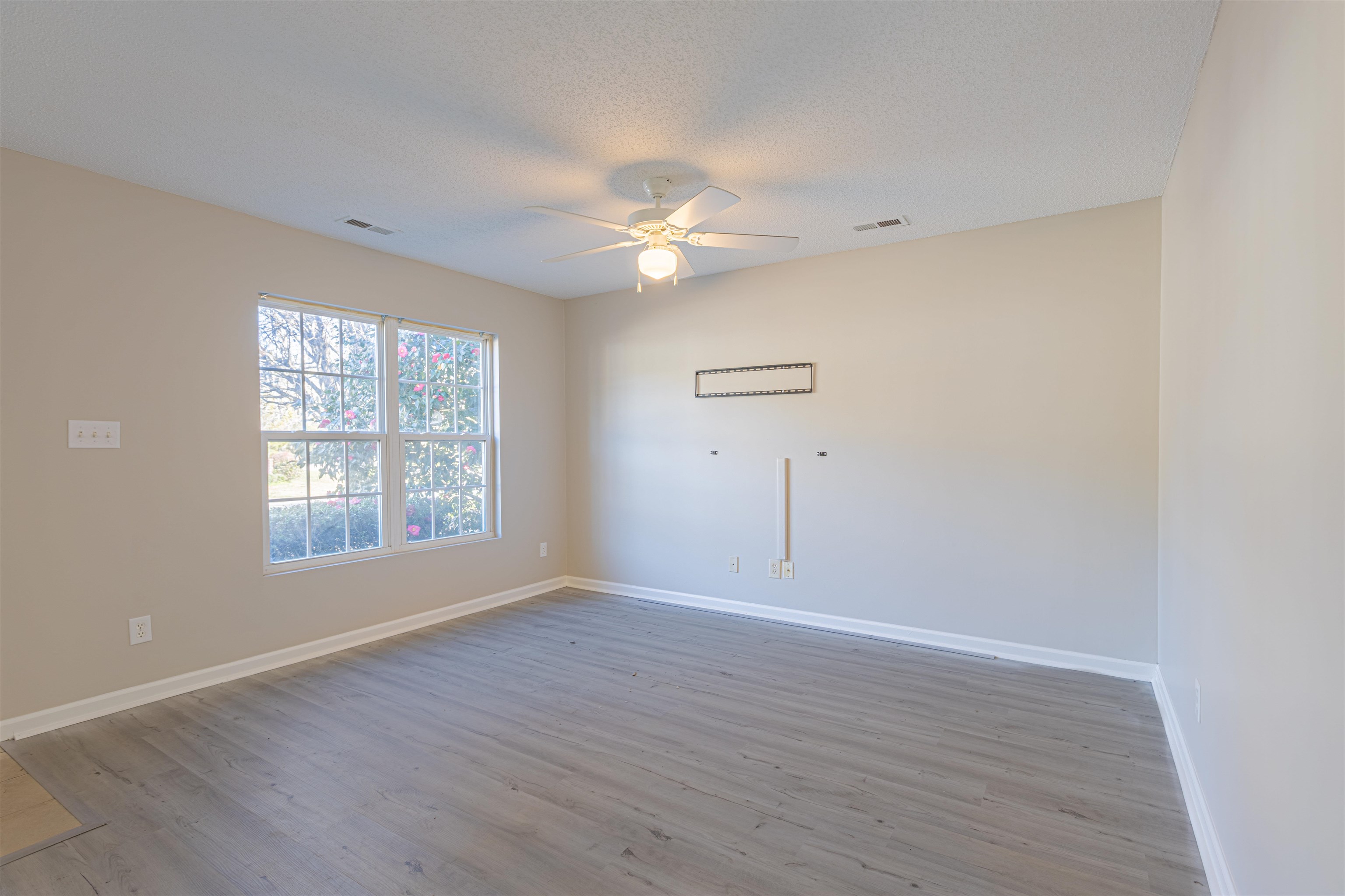 1001 Mistletoe Court Myrtle Beach, SC 29579 - Photo 7 of 28 Spare room with light wood finished floors, a textured ceiling, and a ceiling fan