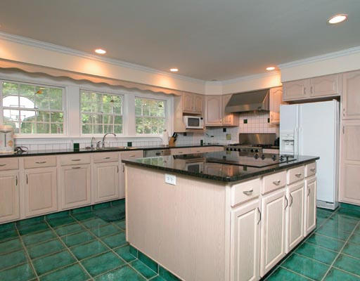 11 Tanglewood Road Newton, MA 02459 - Photo 3 of 4 a kitchen with kitchen island granite countertop a sink stove and cabinets