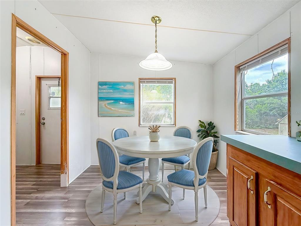 1819 Sinclair Hills Road Lutz, FL 33549 - Photo 23 of 60 a dining room with furniture a chandelier and wooden floor
