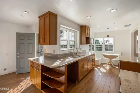 an empty room with wooden floor and window