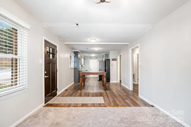 a view of a workspace with furniture and wooden floor