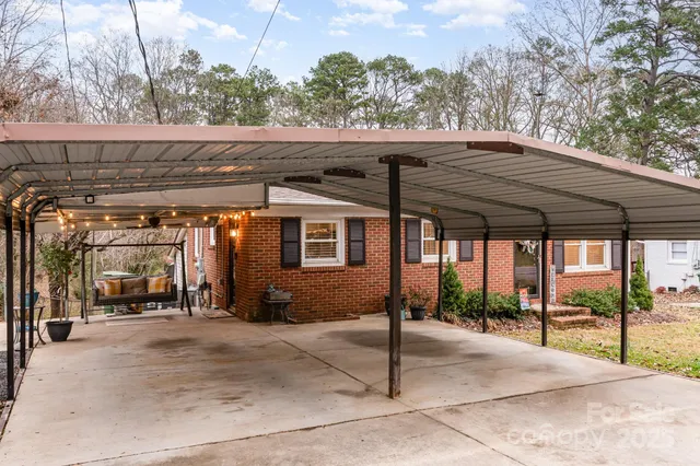a patio with a table and chairs under an umbrella