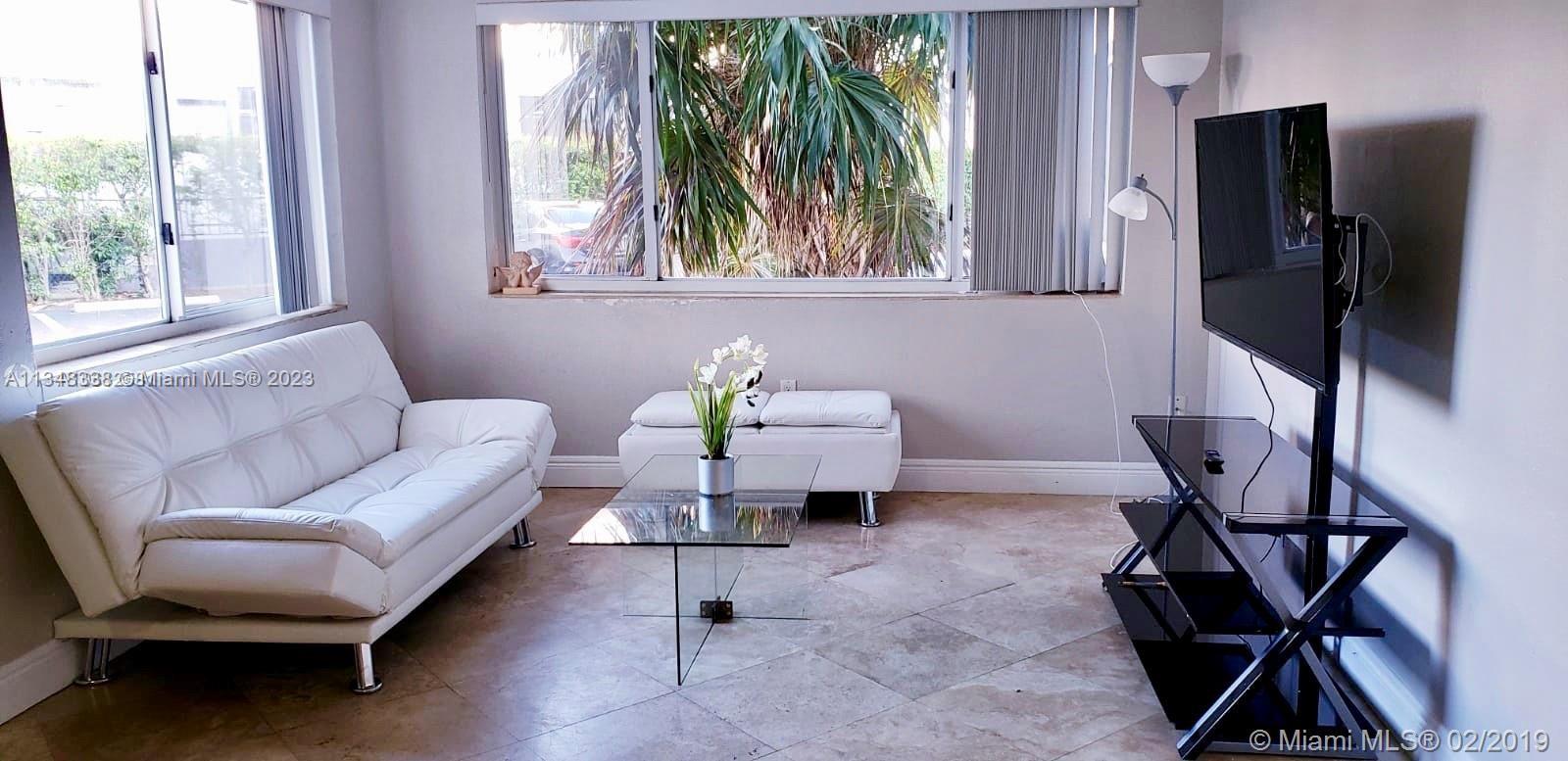 Normandy Isle Miami Beach, FL 33141 - Photo 3 of 12 a living room with furniture and a window