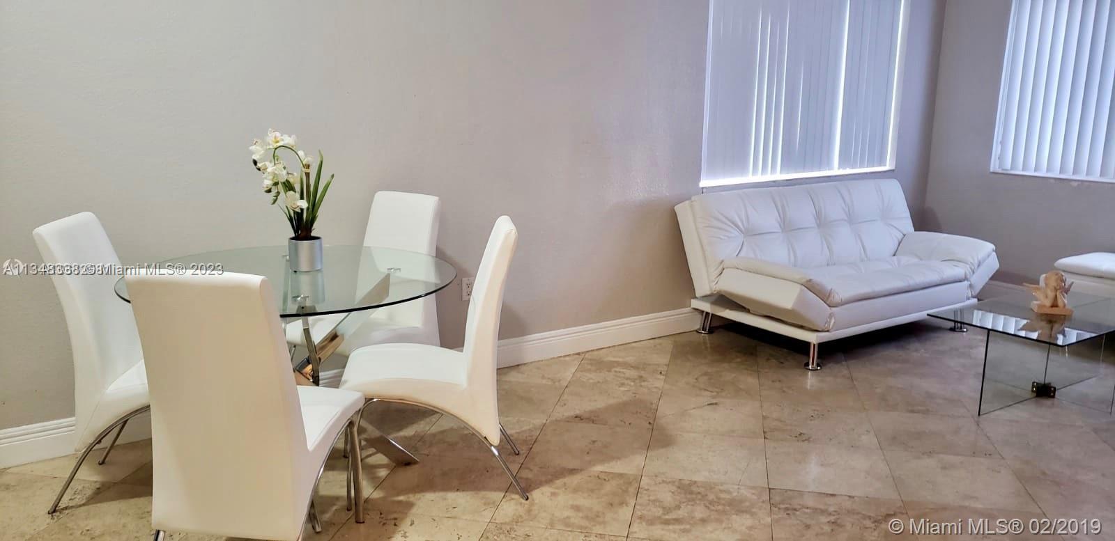 Normandy Isle Miami Beach, FL 33141 - Photo 4 of 12 a living room with furniture and a window