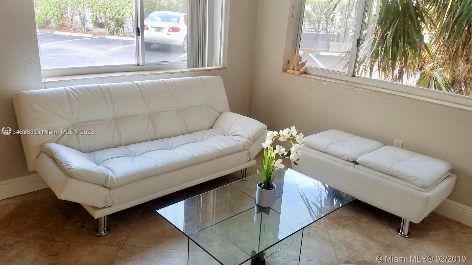 Normandy Isle Miami Beach, FL 33141 - Photo 5 of 12 a living room with furniture and a window