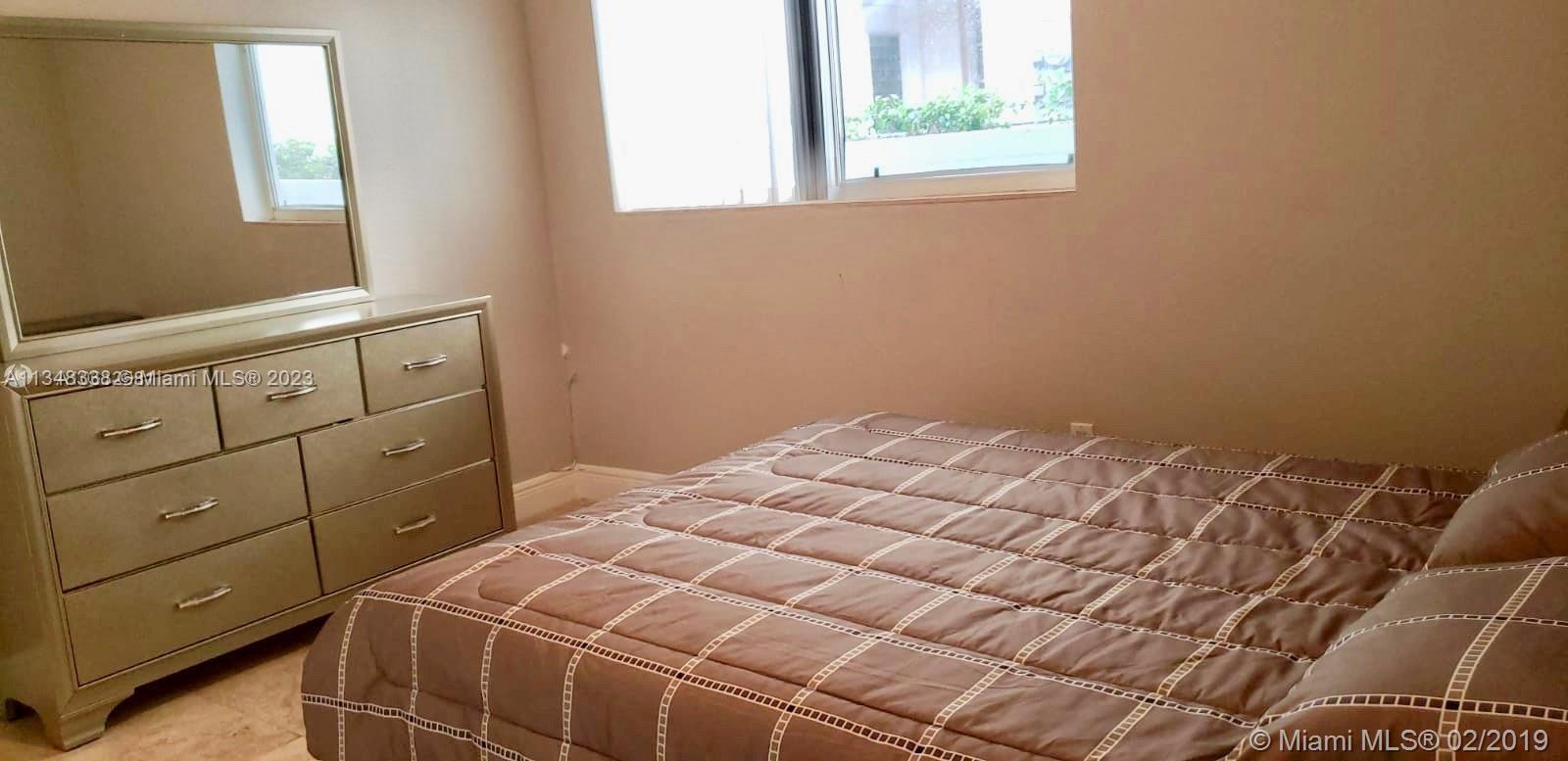 Normandy Isle Miami Beach, FL 33141 - Photo 7 of 12 a bedroom with a bed and a window