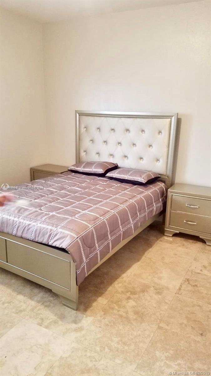 Normandy Isle Miami Beach, FL 33141 - Photo 8 of 12 a bedroom with a bed and cabinet