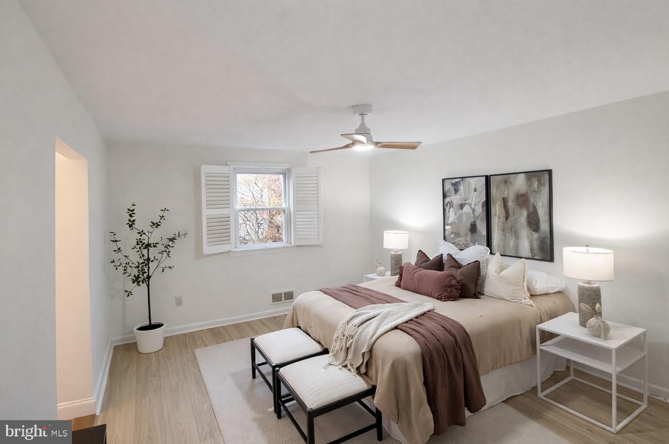 109 Ridgefield Road Lutherville-Timonium, MD 21093 - Photo 11 of 31 a bedroom with a bed and a lamp with window