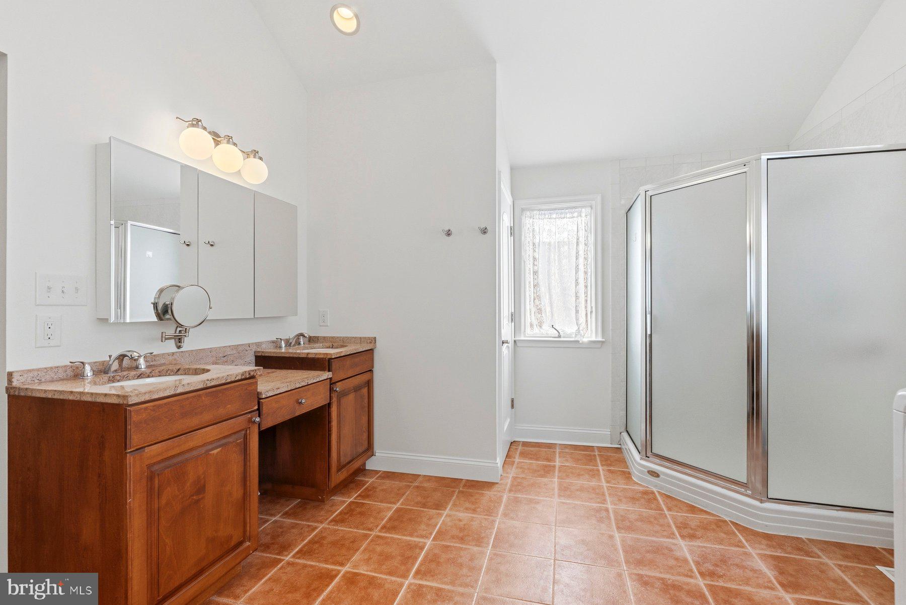 109 Ridgefield Road Lutherville-Timonium, MD 21093 - Photo 15 of 31 a bathroom with a sink a toilet and mirror