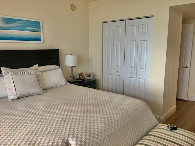 3232 Southwest 22nd Terrace, Unit 1303 Miami, FL 33145 - Photo 17 of 43 a bedroom with a bed and a night stand