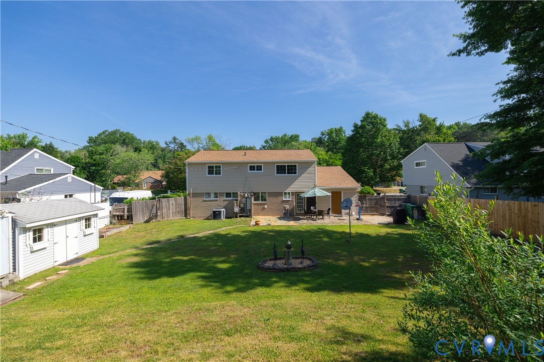 9217 Fisk Road Richmond, VA 23229 - Photo 33 of 39 a view of a house with a big yard potted plants and large tree