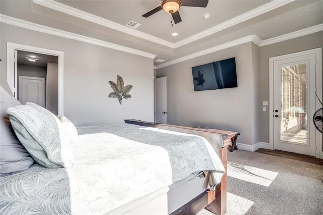 a bedroom with a large bed and a tv