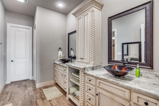 a spacious bathroom with a double vanity sink and a mirror