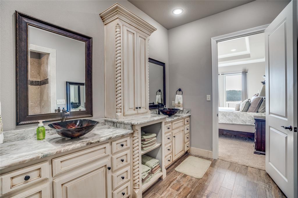 181 Ridgeline Drive Chico, TX 76431 - Photo 18 of 39 a spacious bathroom with a double vanity sink and a mirror
