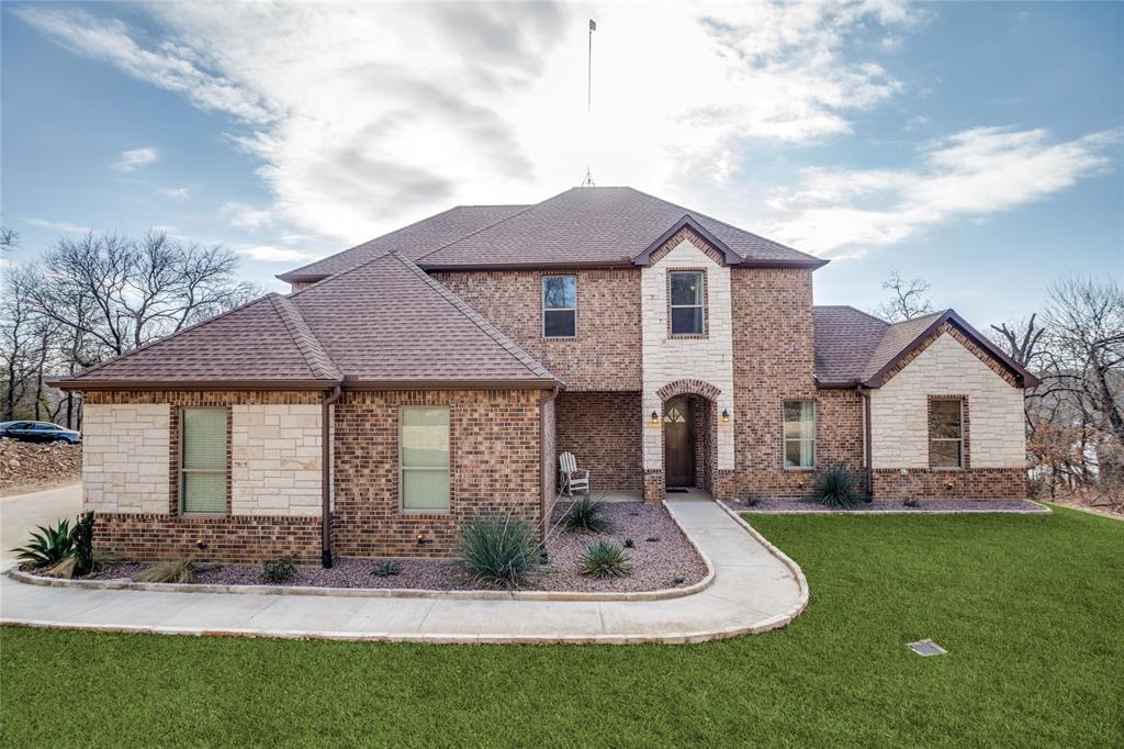 181 Ridgeline Drive Chico, TX 76431 - Photo 2 of 39 a front view of a house with a yard and garage