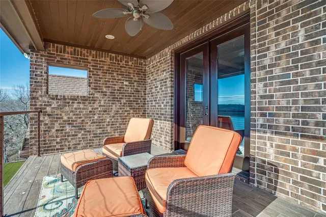 a outdoor space with patio couches and a fireplace