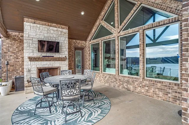 a living room with furniture a fireplace and a floor to ceiling window