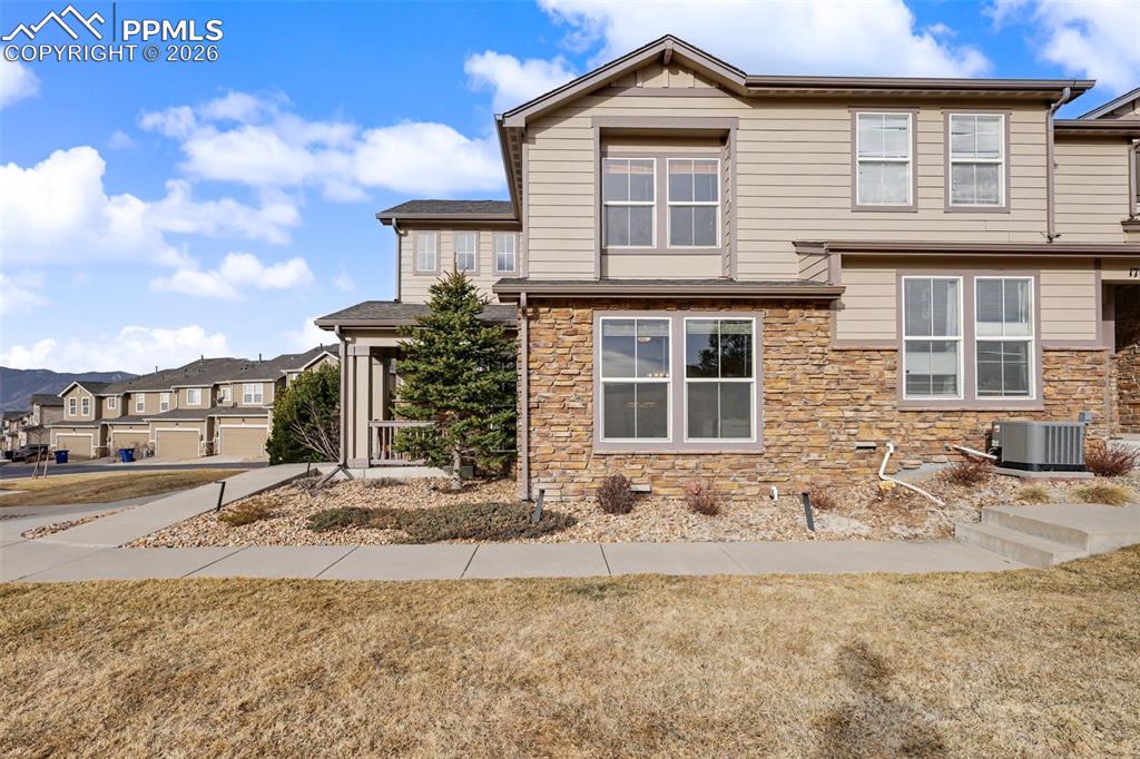17063 Blue Mist Grove Monument, CO 80132 - Photo 4 of 33 a front view of a house with a yard