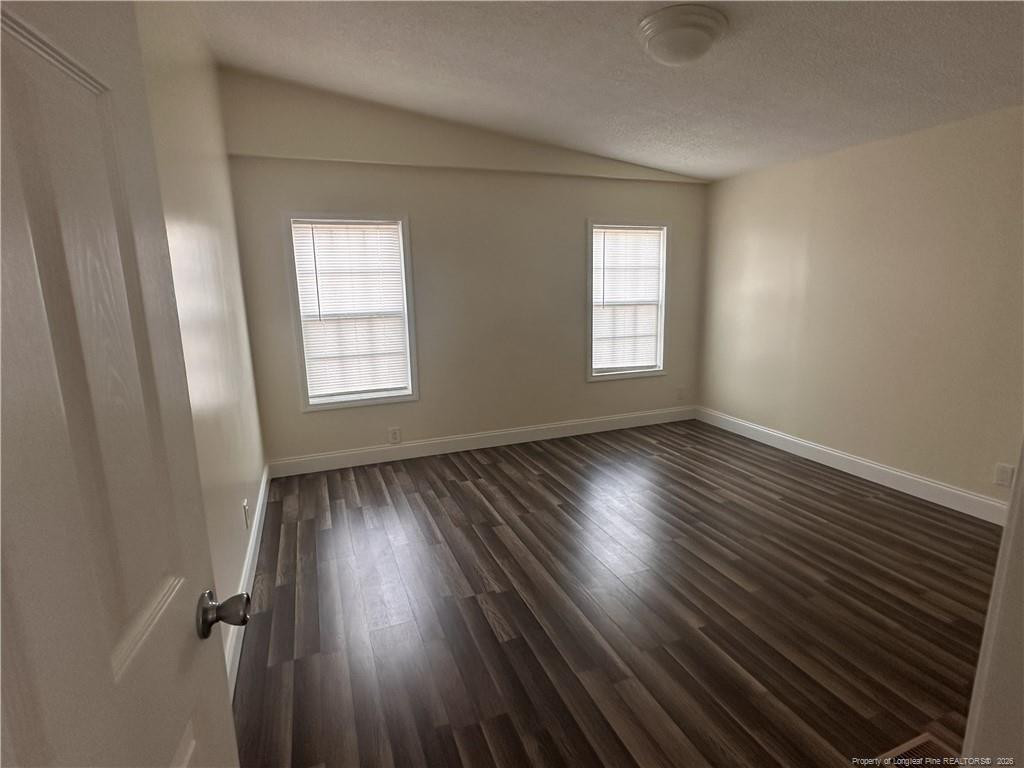 542 Red Oak Farm Road Tar Heel, NC 28392 - Photo 13 of 15 an empty room with wooden floor and windows