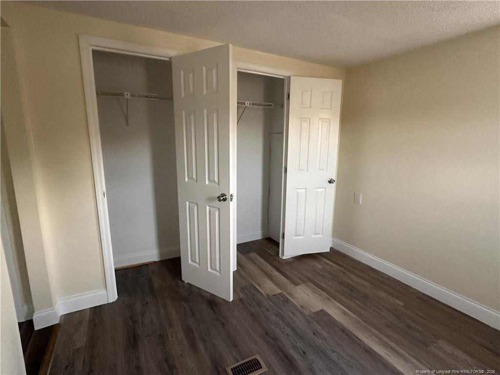 542 Red Oak Farm Road Tar Heel, NC 28392 - Photo 14 of 15 an empty room with wooden floor and closet