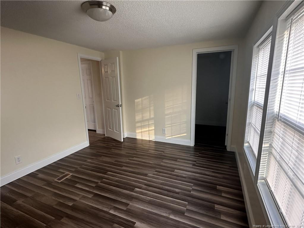 542 Red Oak Farm Road Tar Heel, NC 28392 - Photo 15 of 15 a view of an empty room with wooden floor and a window