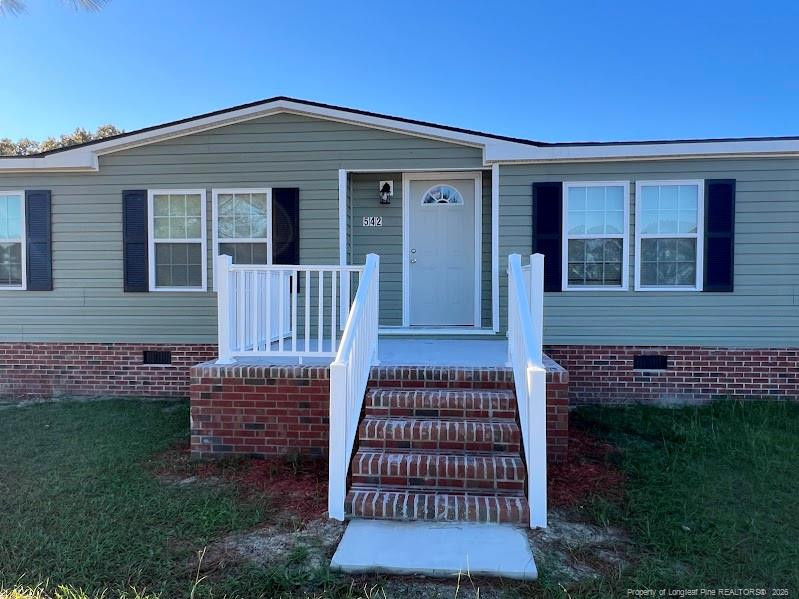 542 Red Oak Farm Road Tar Heel, NC 28392 - Photo 3 of 15 front view of a house with a yard