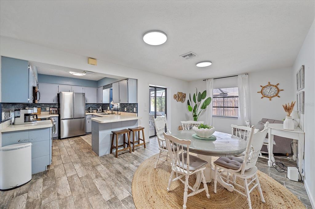108 Stanford Road Venice, FL 34293 - Photo 12 of 28 a kitchen with stainless steel appliances kitchen island granite countertop a sink and cabinets