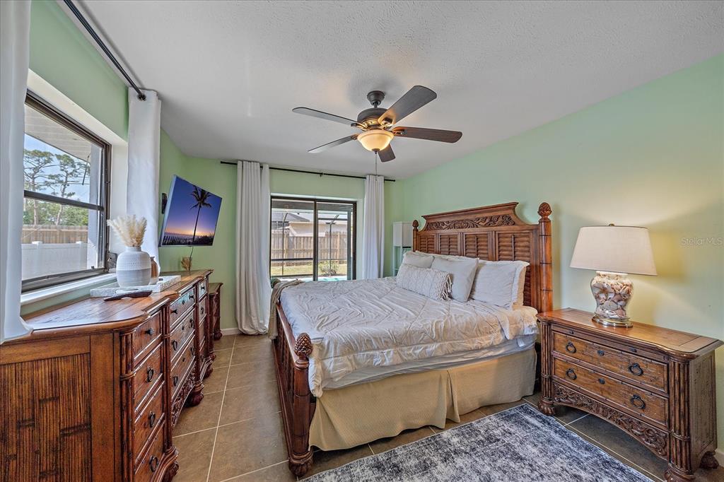 108 Stanford Road Venice, FL 34293 - Photo 15 of 28 a bedroom with a bed and a chandelier