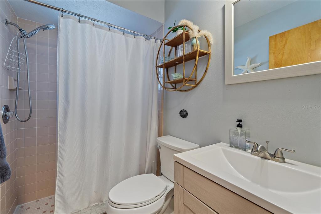 108 Stanford Road Venice, FL 34293 - Photo 20 of 28 a bathroom with a sink vanity mirror and toilet