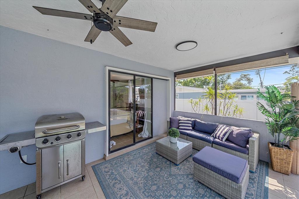108 Stanford Road Venice, FL 34293 - Photo 22 of 28 a living room with furniture and a floor to ceiling window