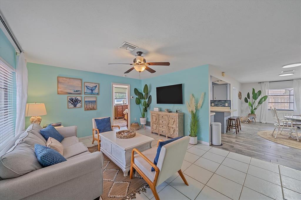 108 Stanford Road Venice, FL 34293 - Photo 4 of 28 a living room with furniture and a flat screen tv