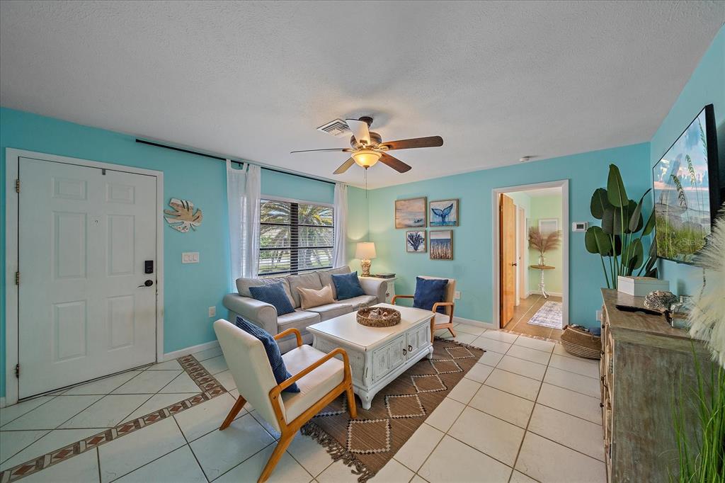 108 Stanford Road Venice, FL 34293 - Photo 7 of 28 a living room with furniture and a chandelier