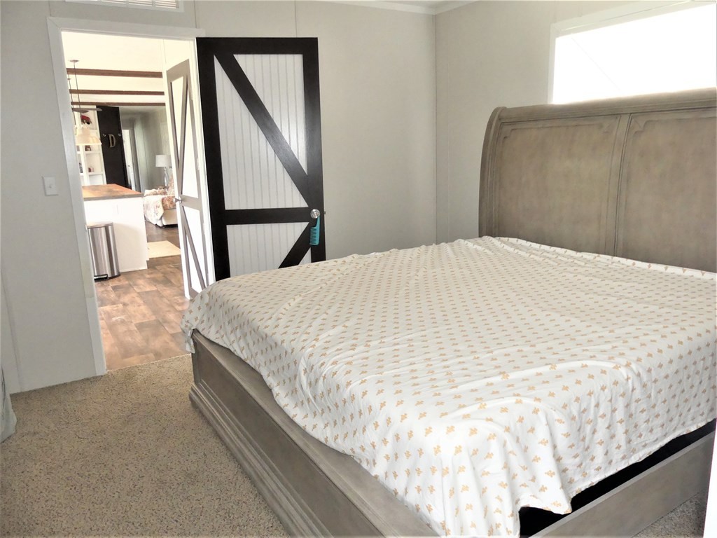 211 Cottonport Ferry Road Decatur, TN 37322 - Photo 15 of 41 a bed sitting in a bedroom next to a window