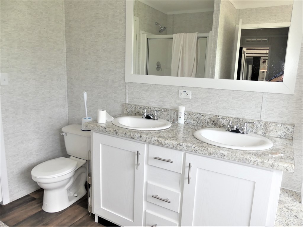 211 Cottonport Ferry Road Decatur, TN 37322 - Photo 16 of 41 a bathroom with a granite countertop sink and a toilet