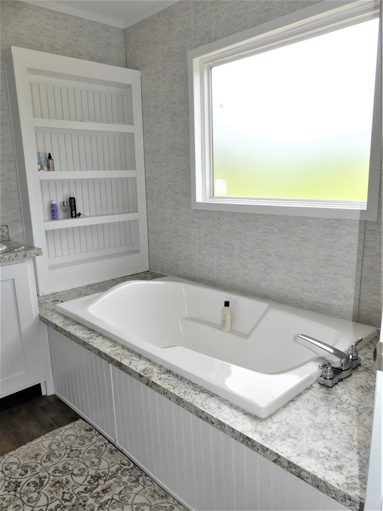 211 Cottonport Ferry Road Decatur, TN 37322 - Photo 17 of 41 a bathroom with a granite countertop sink and a bathtub