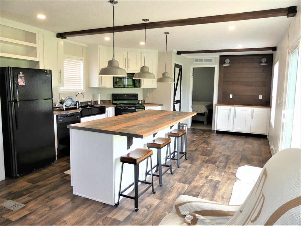 211 Cottonport Ferry Road Decatur, TN 37322 - Photo 8 of 41 a kitchen with stainless steel appliances a dining table chairs and wooden floor