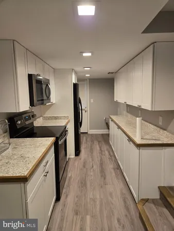a kitchen with a sink stove and refrigerator