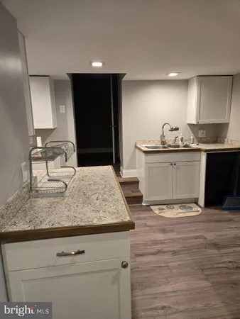 a kitchen with stainless steel appliances granite countertop a sink and cabinets