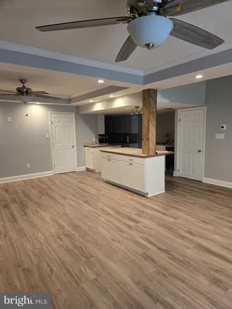 a view of a livingroom with kitchen and a window