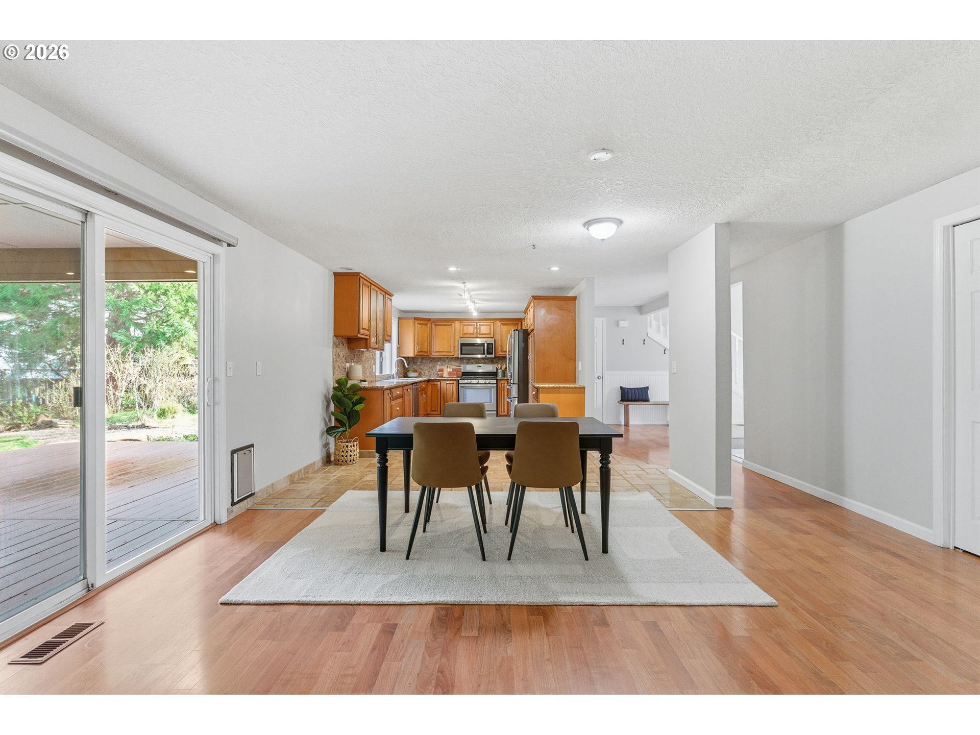 5585 Northwest Peregrine Place Portland, OR 97229 - Photo 12 of 47 a view of a dining room with furniture window and wooden floor