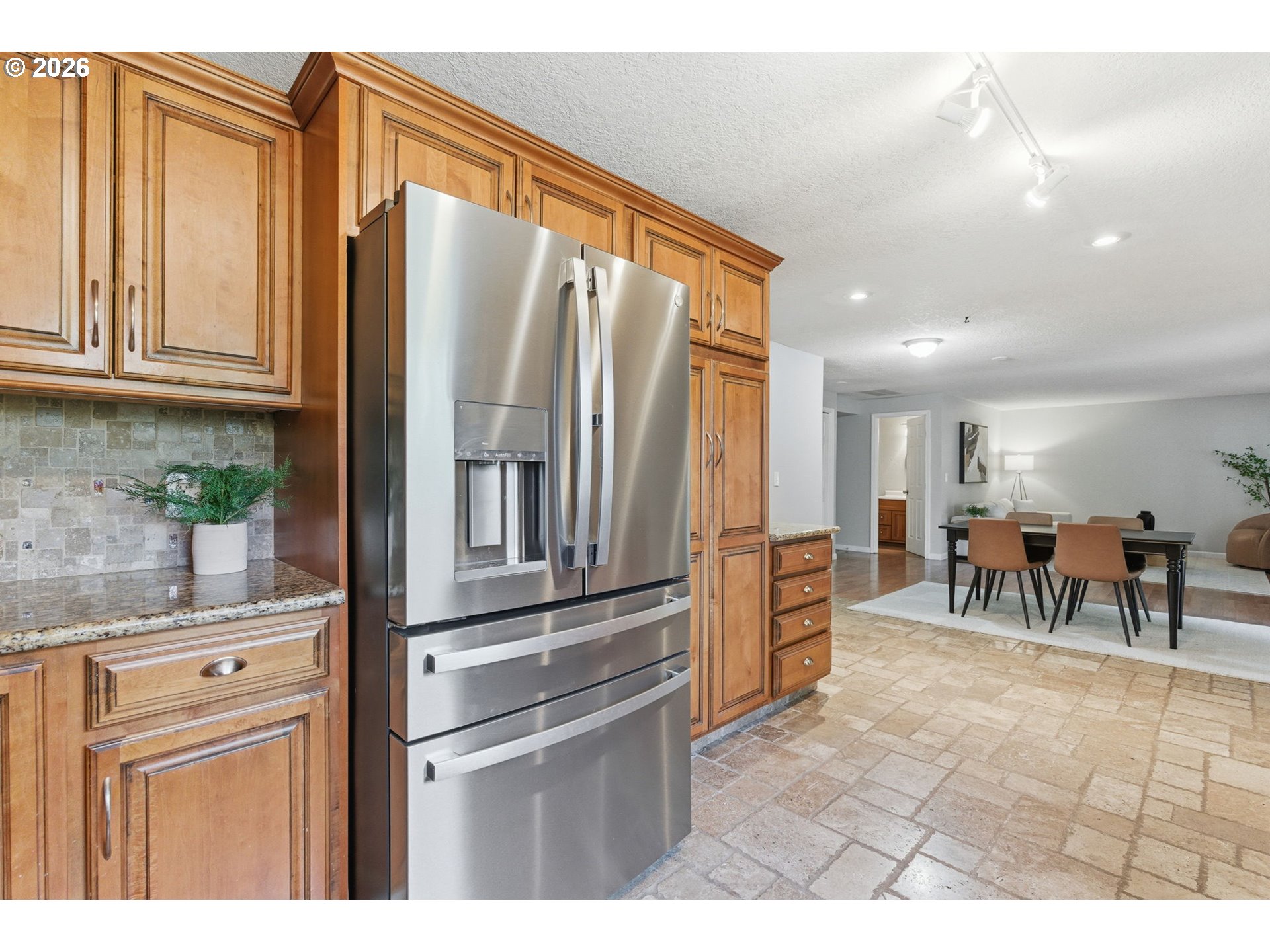 5585 Northwest Peregrine Place Portland, OR 97229 - Photo 19 of 47 a kitchen with stainless steel appliances granite countertop a refrigerator and a sink