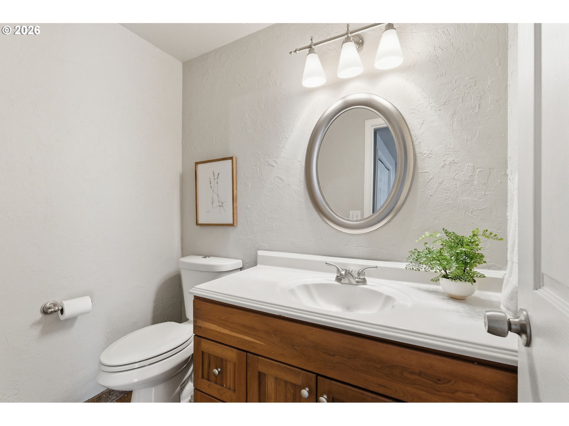 5585 Northwest Peregrine Place Portland, OR 97229 - Photo 25 of 47 a bathroom with a sink vanity mirror and toilet